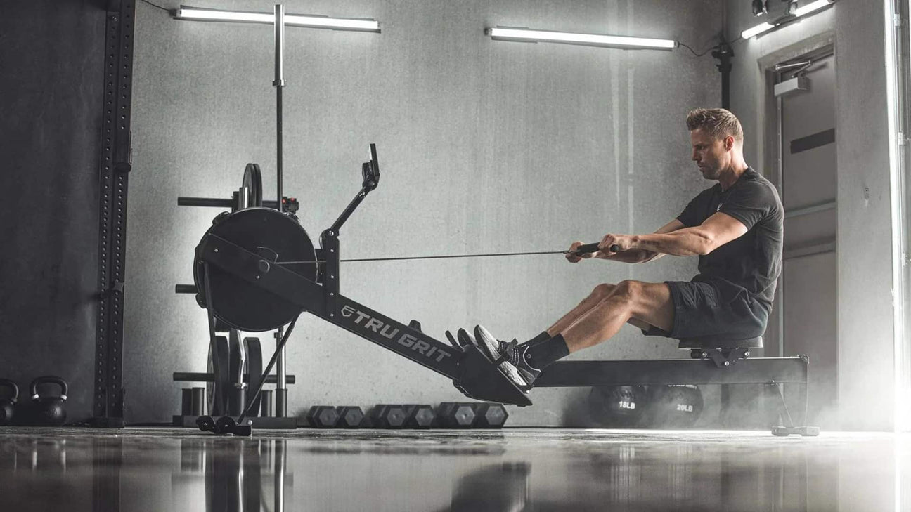 man using tru grit rowing machine in gym lifestyle image