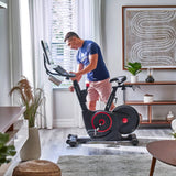 Man using Echelon EX-5s Smart Connect Bike in living room 