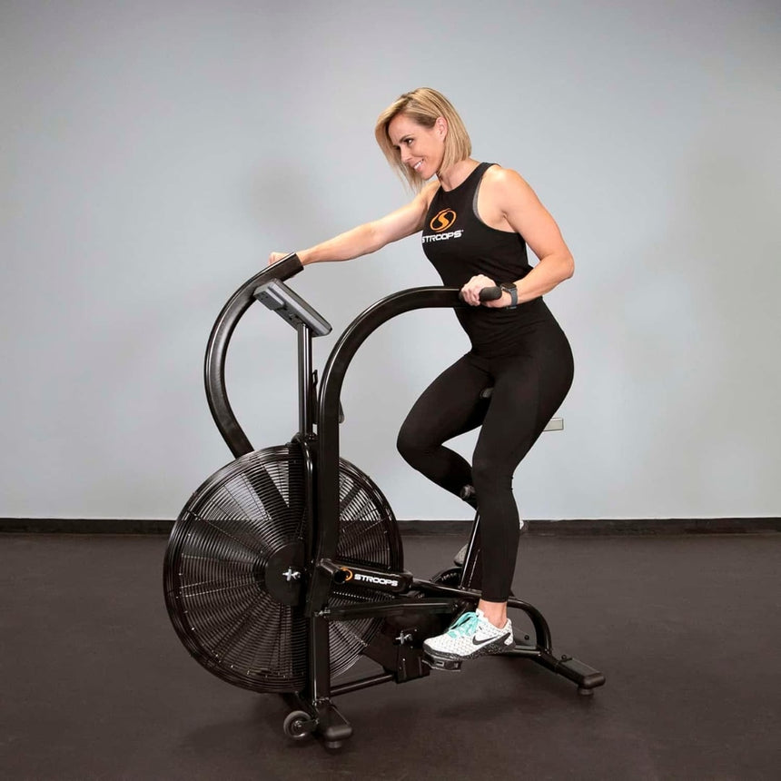 Woman using Stroops Air Bike in gym