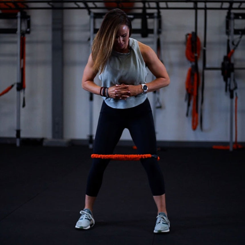 Woman using Deluxe Loop Resistance Band