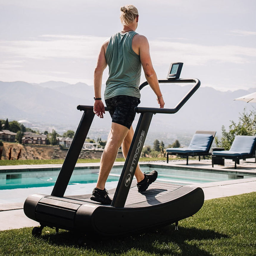 man using Opticurve Curved Treadmill outdoors