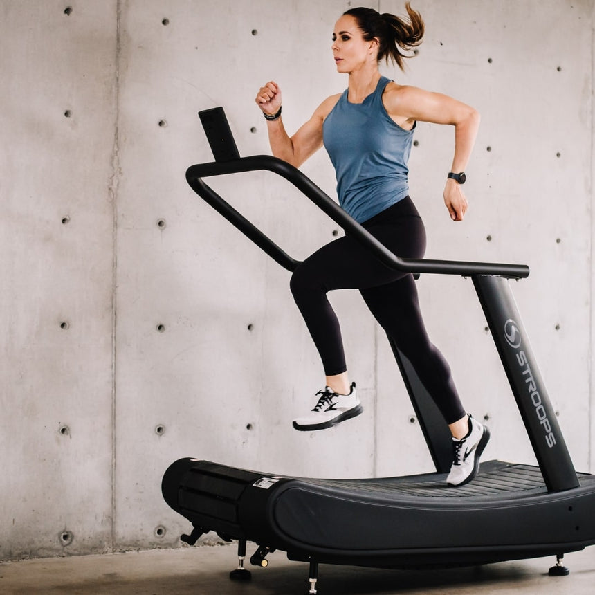 woman using Opticurve Curved Treadmill 