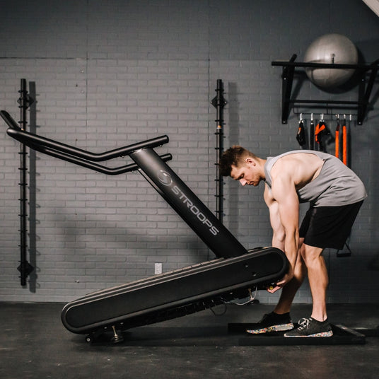 Man moving Optimill® Flat Motorless Treadmill