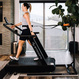 Woman using Optimill® Flat Motorless Treadmill in home