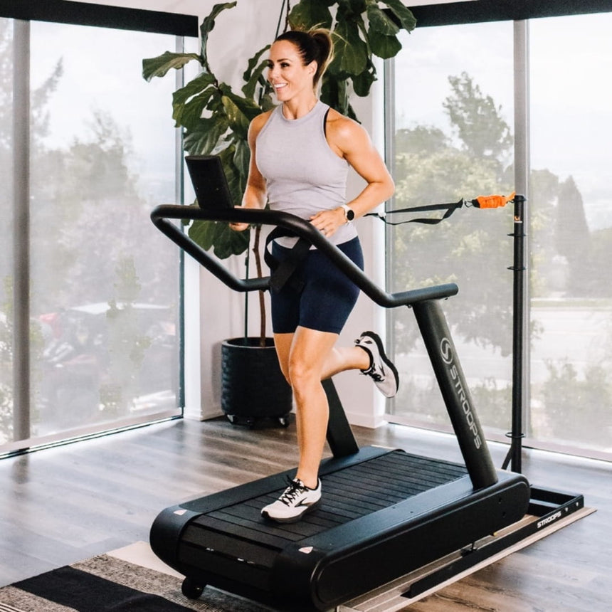 Woman using Optimill® Flat Motorless Treadmill in home