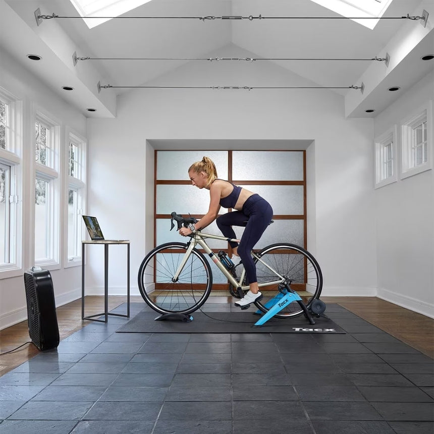 Woman using the Garmin Tacx® Boost Trainer Bundle