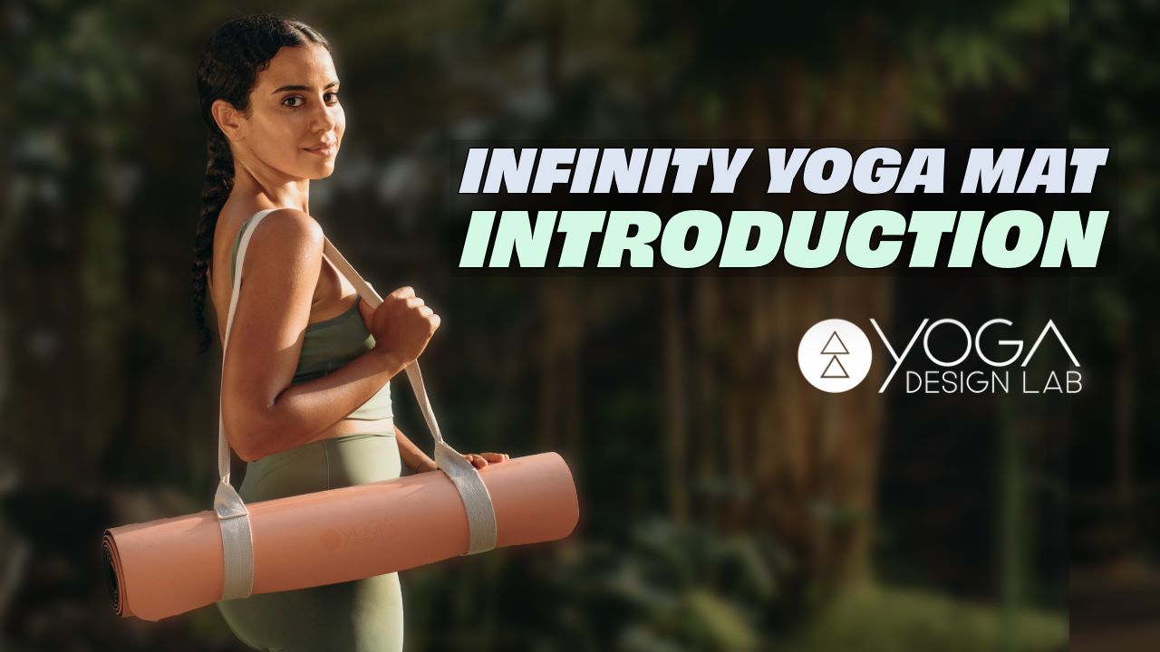 woman holding a Yoga Design Lab Infinity Yoga mat in naturistic setting