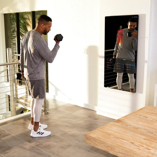 man using Echelon Reflect 50" Smart Fitness Mirror in home 