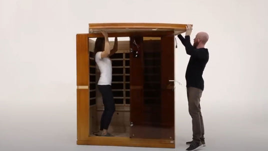 man and woman putting together a dynamic infrared sauna