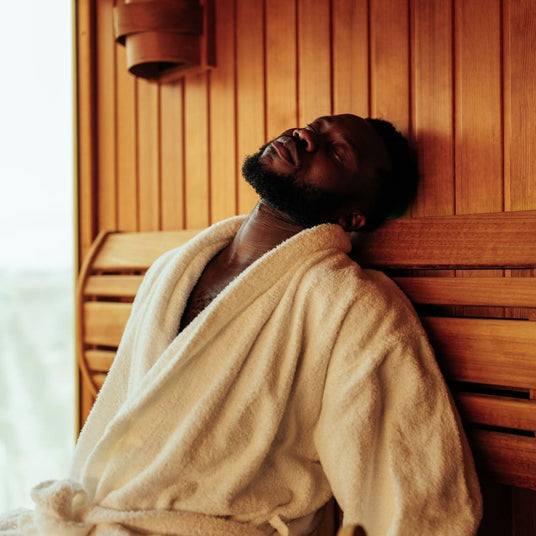 man relaxing in an indoor home sauna 