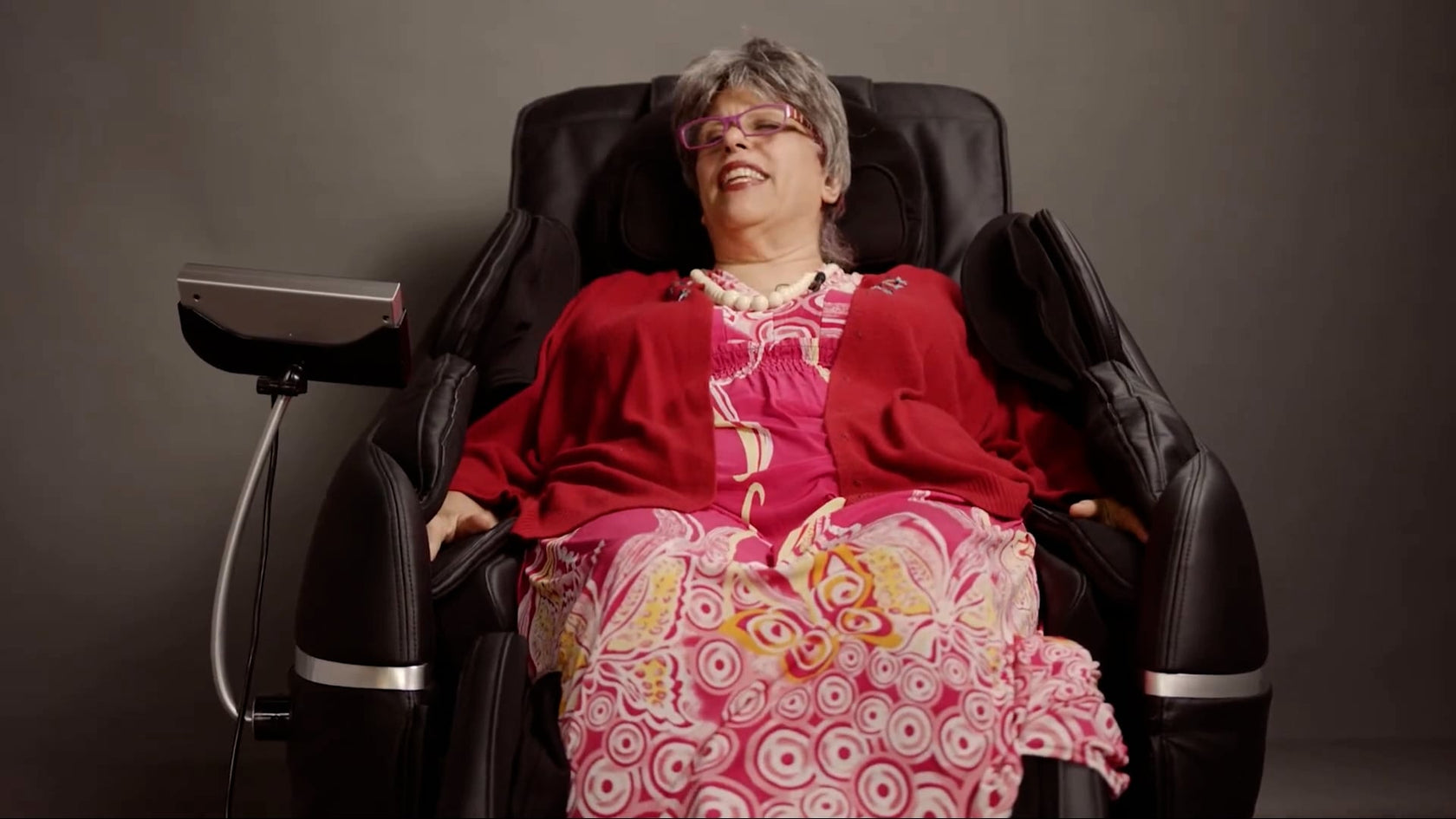 Woman smiling and relaxed in a medical breakthrough massage chair 