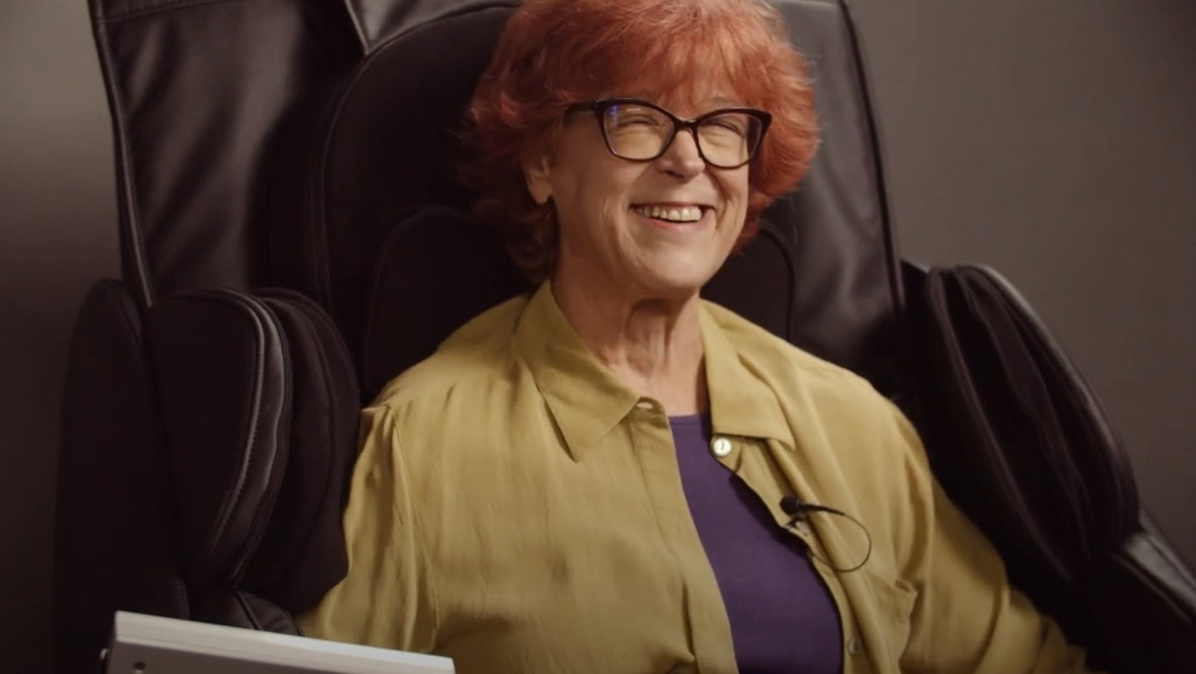 woman smiling in joy while using the medical breakthrough massage chair